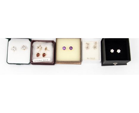 A collection of 9ct gold and unmarked yellow metal and gem set earrings to include a garnet drop pair set with oval garnets, 