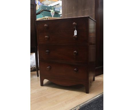 A Victorian mahogany commode in the form of a chest of drawers, circa 1850, the upper half opening to reveal a large space, f