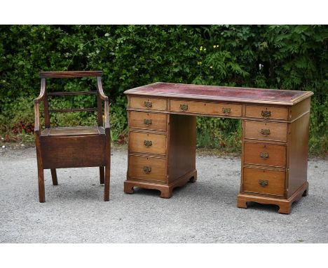 A George III mahogany open armchair commode, together with a good late Victorian faded mahogany knee hole desk with red leath