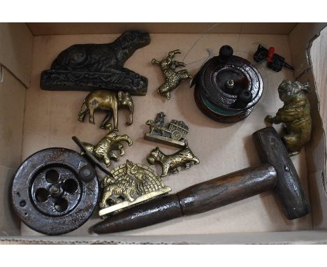 Vintage fishing reels, along with brass dogs and elephant.
