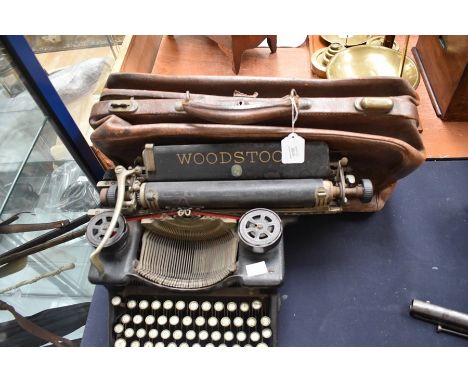 An American Woodstock standard typewriter model 5N together with a Vintage leather travelling bag (2)&nbsp;