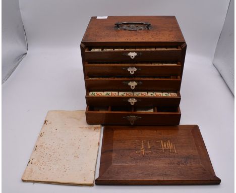 A vintage Mah-Jong set in hardwood case, the interior with five drawers, steel carrying handle, sliding front section, with b