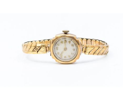 A 1930's 9ct gold ladies watch, machine engraved guilloche enamel dial with applied gold tone number markers, case apporox 20