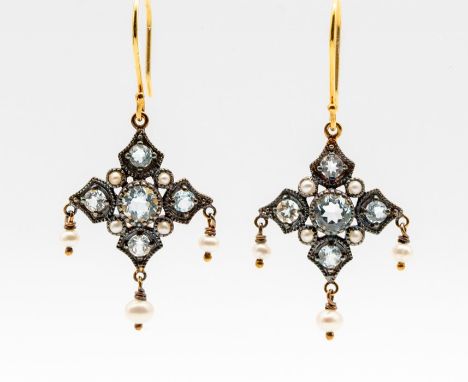 A pair of vintage style arabesque blue topaz and pearl, silver gilt earrings, comprising a round cut blue topaz set to the ce
