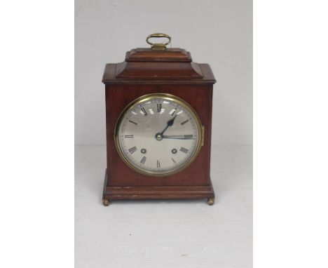 Early 20th century English made mahogany bracket clock with round dial and Roman numerals.