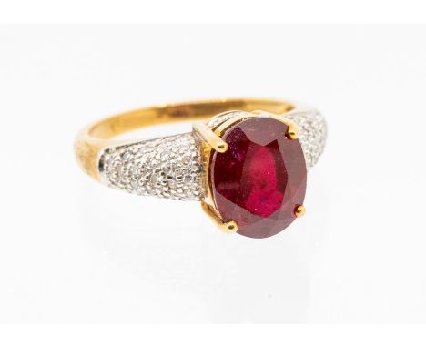 A ruby and diamond 9ct white gold ring, the oval cut claw set ruby weighing approx 4.15carats, with pave set diamond shoulder