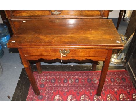 A George III mahogany fold-over card table, fitted with a single drawer, raised on square legs, 73cm high, 94cm wide, 44cm de