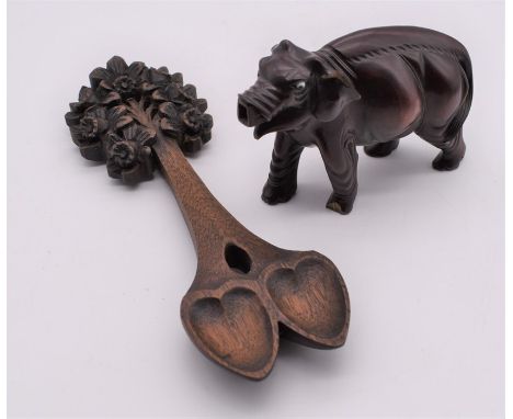 Chinese hardwood elephant missing trunk and ivory tusks along with a hand carved fold art lovers spoon.