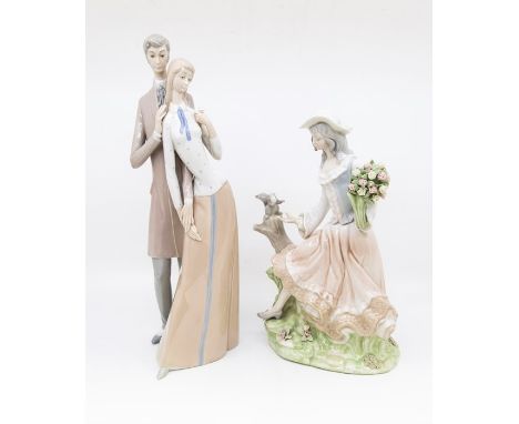 A Lladro style model of a couple, she holds a parasol, stamped Made in Spain to base and a Tenora model of a Lady holding flo