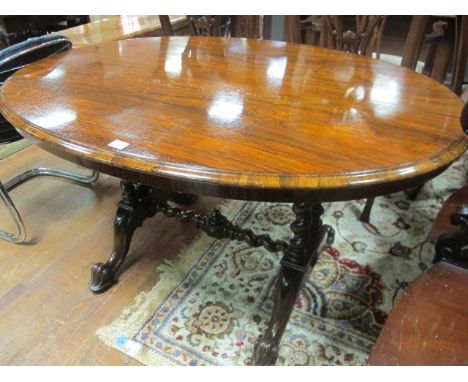 A GOOD VICTORIAN ROSEWOOD OVAL TOP TABLE on twin pillar supports 135cm x 96cm