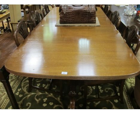 A GOOD MAHOGANY TWIN PILLAR DINING TABLE the reeded top with inset leaf on pineapple carved pedestals with brass casters 247c