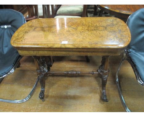 A VERY FINE VICTORIAN WALNUT INLAID FOLD OVER CARD TABLE the rectangular hinged top containing a baize lined interior raised 