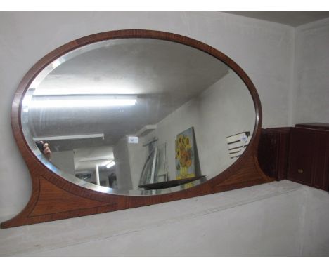 A CONTINENTAL KINGWOOD AND EBONISED INLAID MIRROR of oval outline the bevelled plate within a moulded frame 73cm x 127cm