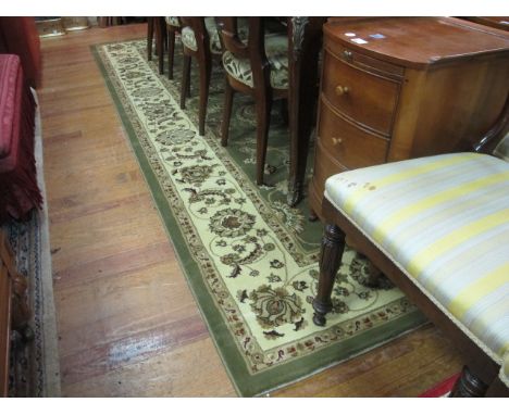 A COLTSWOLD COLLECTION RUG the light green and beige ground with central floral panel within a conforming border 330cm x 240c