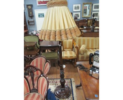 A MAHOGANY STANDARD LAMP with carved decoration and pleated shade