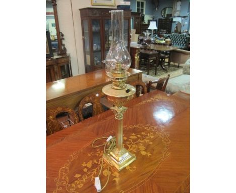 A CORINTHIAN COLUMN BRASS LAMP with glass globe