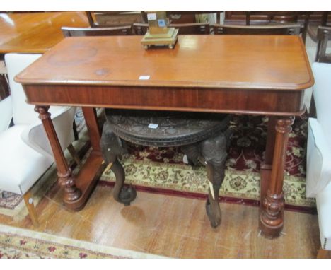 A VICTORIAN MAHOGANY SIDE TABLE with turned fluted legs and cross stretcher 124cm wide