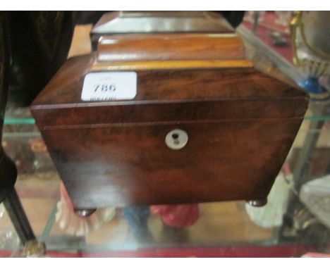 A VICTORIAN MAHOGANY TEA CADDY of rectangular tapering form the hinged lid containing compartments raised on bun feet