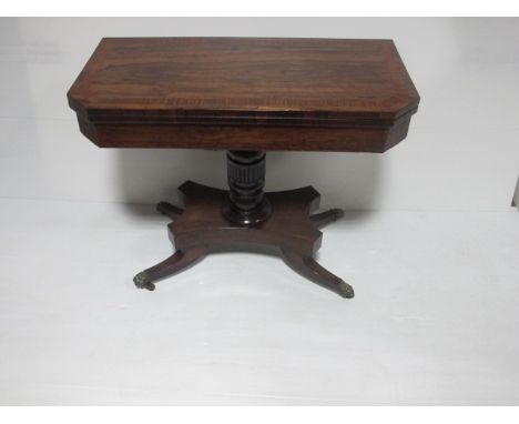 A GOOD REGENCY ROSEWOOD CARD TABLE with satinwood cross banding fluted pillar and platform base