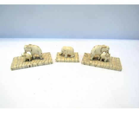 Three antique ivory elephants and an antique Chinese scroll arm