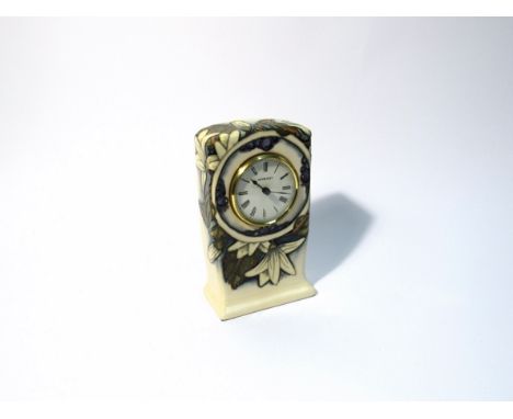 A Moorcroft Juneberry pattern clock, designed by Anji Davenport, 16cm tall