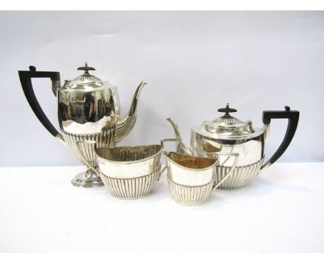 A Henry Wilkinson &amp; Co. silver three piece tea set, London 1894, with an associated Walker &amp; Hall silver cream jug, S