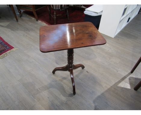 A 19th Century flame mahogany wine table, the round cornered top over a turned column and tripod base, 74cm tall x 42cm x 58c