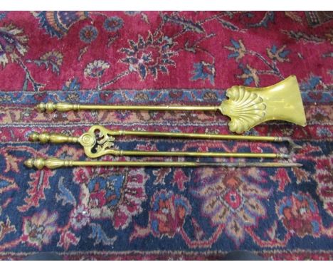 A set of three brass fire tools 