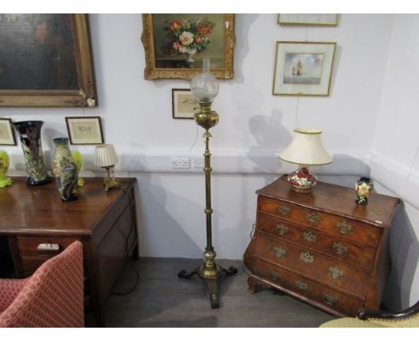 A 19th Century brass standard oil lamp, etched glass globular shade over brass reservoir and column to outswept hardwood base