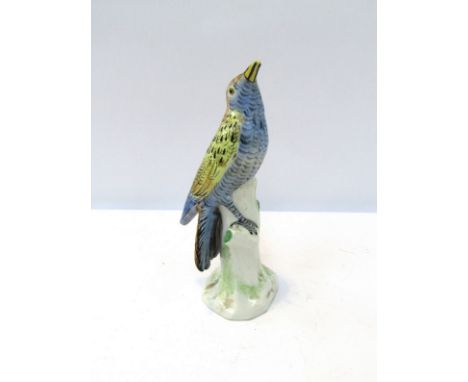 A ceramic model of a bird, cross swords mark to base, beak restored, 22cm tall