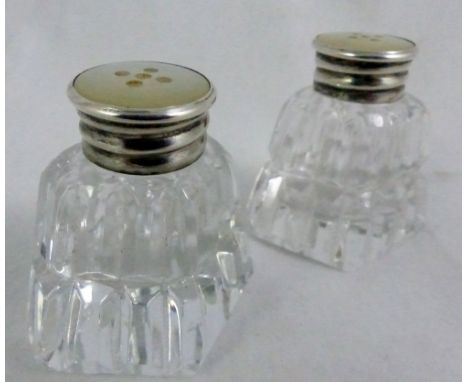 Pair of cut glass pepperettes with silver and mother of pearl tops