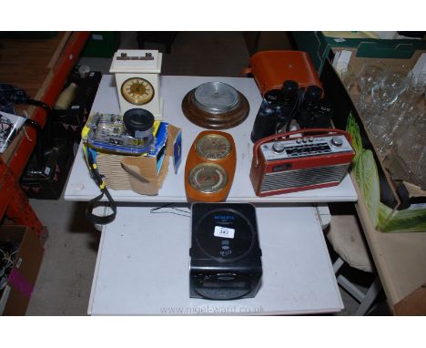 A pair of 10 x 80 binoculars, clocks, two "Roberts" radios, underwater camera housing, etc.,