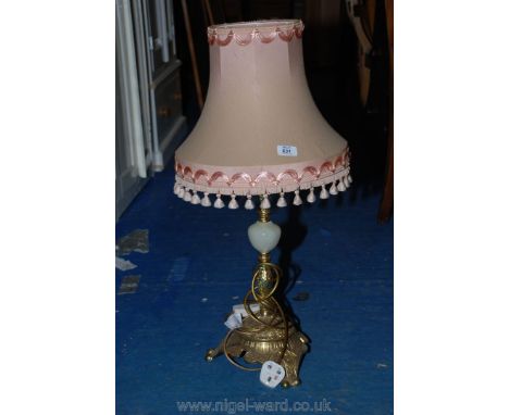 A brass and Onyx table lamp with a pink tasselled shade.