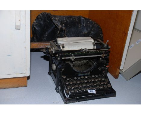 An "Underwood" typewriter with original waxed linen cover.