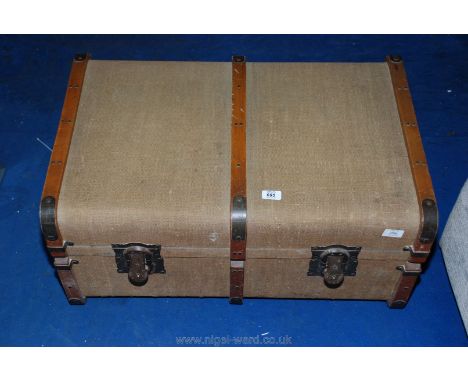 A bent-wood bound travel trunk.