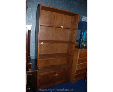 A Satinwood four-shelf unit over two-doored cupboard base, 37" x 76" x 11" deep.