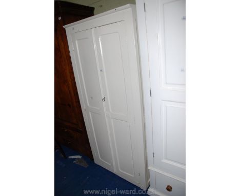 A two-door, painted three shelf cupboard with key, 32" x 68" x 17" deep.