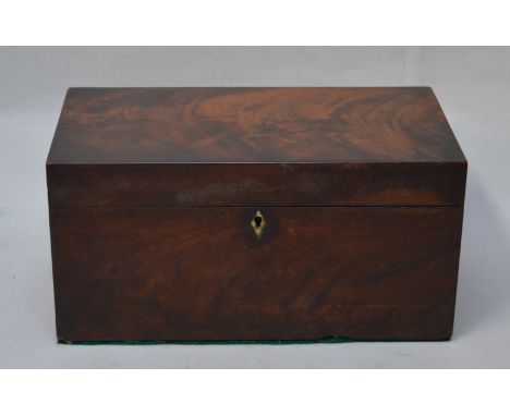 A Georgian flame mahogany two division tea caddy with glass mixing bowl.