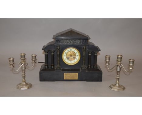 An early 20th century ornate cased chiming mantle clock with enamel face, pendulum and brass plaque to front dated 1906. Toge