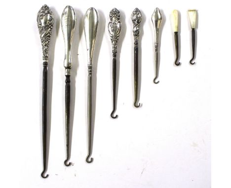 Six various silver handled button hooks and two smaller button hooks