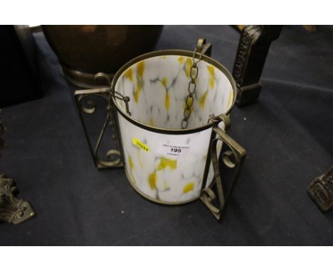 A mottled glass and brass light shade