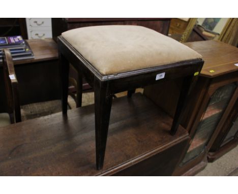 A mahogany dressing stool raised on square tapering supports