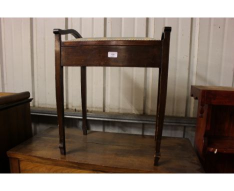 A mahogany piano stool with lift up top