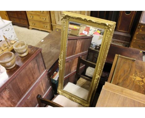 An ornate gilt framed oblong wall mirror