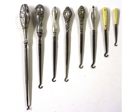 Five various silver handled button hooks and three other button hooks