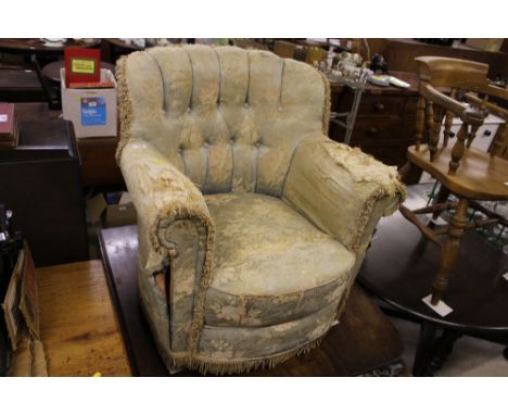 An early 20th Century upholstered button back armchair