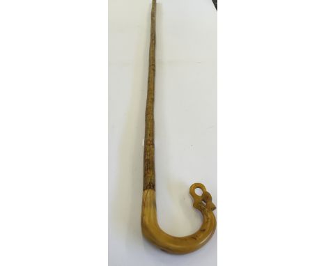 A carved horn handle walking stick.