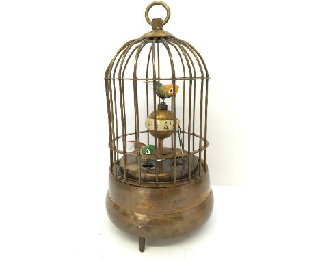 A brass cased clockwork automaton style clock modelled as a birdcage.