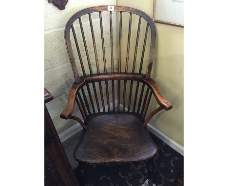 A 19th century stick back ladies' Windsor chair, resting on cross stretcher turned supports.