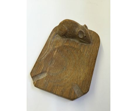 Robert Thompson (Mouseman): An oak canted rectangular ashtray, cigarette cut outs with carved Mouse signature to side.